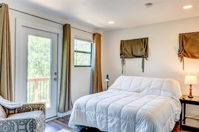 bedroom featuring access to exterior and dark hardwood / wood-style floors