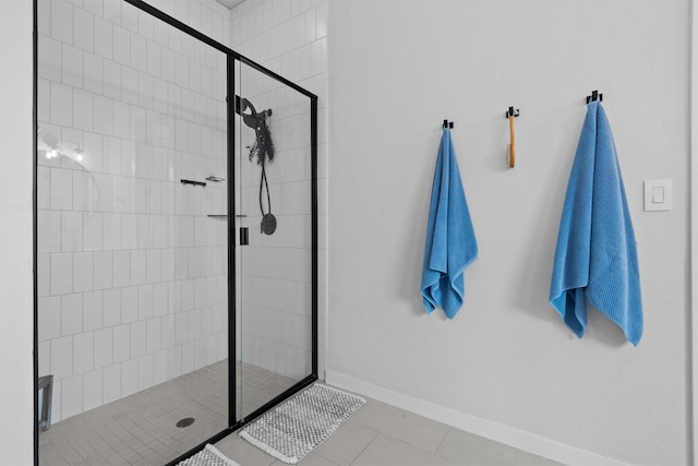 bathroom featuring tiled shower and tile patterned flooring