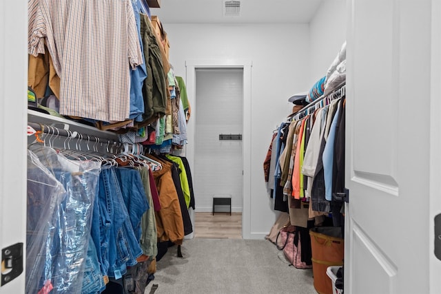 walk in closet featuring carpet