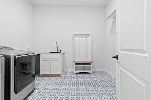 laundry room with washer and dryer, cabinets, and sink