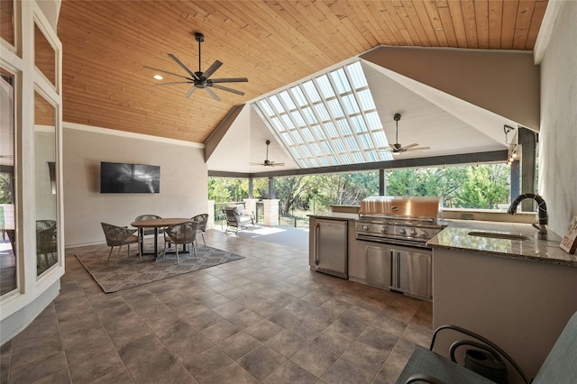 view of patio / terrace featuring area for grilling, sink, ceiling fan, and a grill