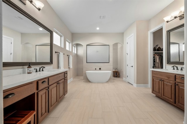 916 Morning Moon Cir, Austin, TX 78732 - full bath featuring two vanities, a soaking tub, and recessed lighting