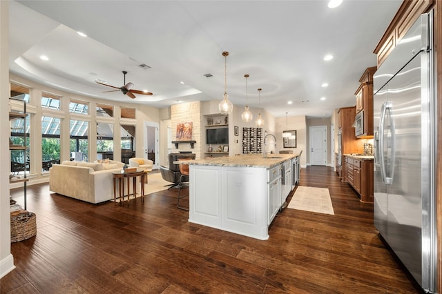 916 Morning Moon Cir, Austin, TX 78732 - kitchen featuring appliances with stainless steel finishes, open floor plan, a ceiling fan, a kitchen breakfast bar, and recessed lighting