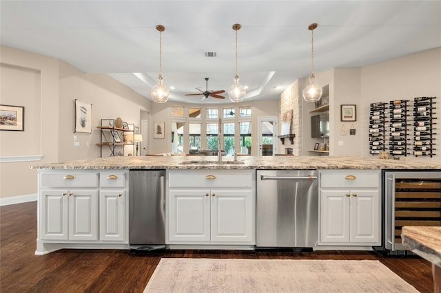 916 Morning Moon Cir, Austin, TX 78732 - kitchen featuring wine cooler, dishwasher, a ceiling fan, dark wood-type flooring, and white cabinets