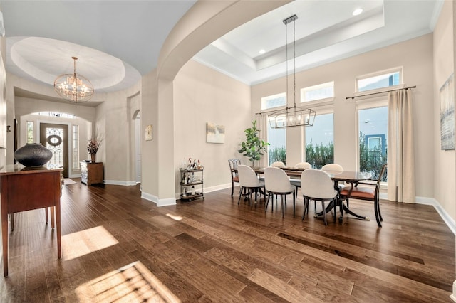 916 Morning Moon Cir, Austin, TX 78732 - dining space featuring a tray ceiling, a chandelier, arched walkways, recessed lighting, and a high ceiling