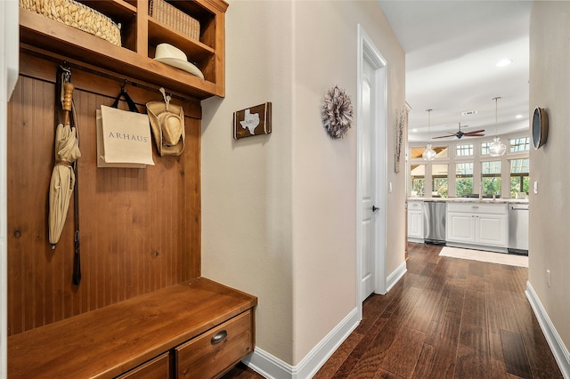 mudroom with dark wood-type flooring and ceiling fan