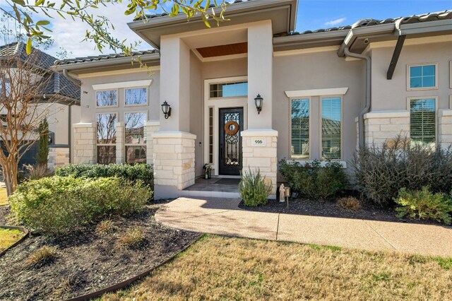 916 Morning Moon Cir, Austin, TX 78732 - doorway to property featuring stone siding, stucco siding, and a tiled roof