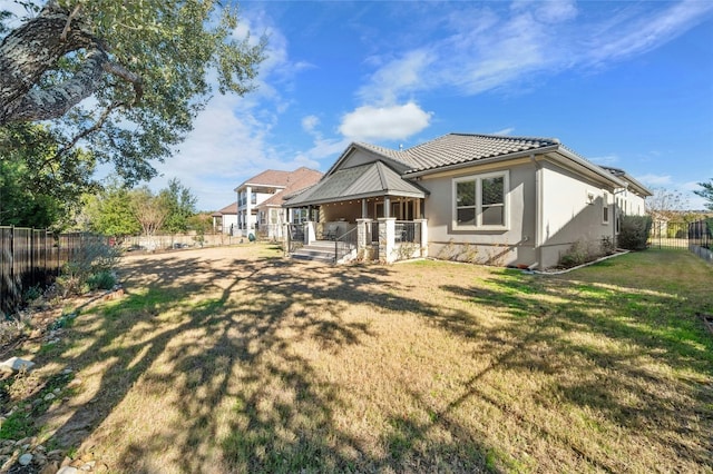 916 Morning Moon Cir, Austin, TX 78732 - back of property with a fenced backyard, a tiled roof, and stucco siding