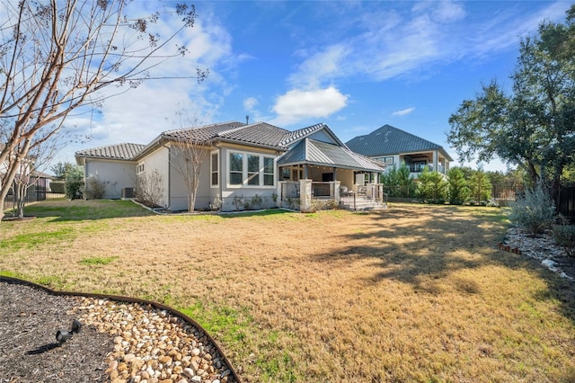 916 Morning Moon Cir, Austin, TX 78732 - back of house featuring a tile roof, stucco siding, and a yard