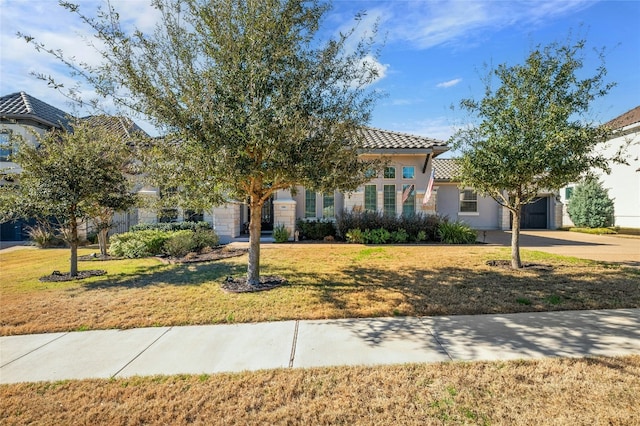 916 Morning Moon Cir, Austin, TX 78732 - view of front of home featuring driveway, a tile roof, a front yard, an attached garage, and stucco siding