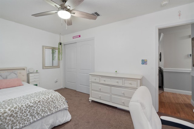 carpeted bedroom featuring a closet and ceiling fan