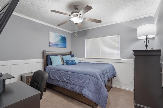 carpeted bedroom with ceiling fan, a textured ceiling, and crown molding