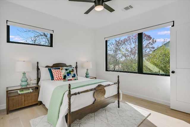 612 Irma Dr Unit 2, Austin, TX 78752 - bedroom with multiple windows, wood finished floors, and baseboards