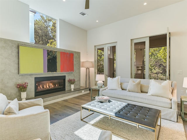 living room featuring ceiling fan and hardwood / wood-style floors