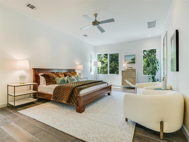 bedroom featuring wood finished floors, visible vents, and a ceiling fan