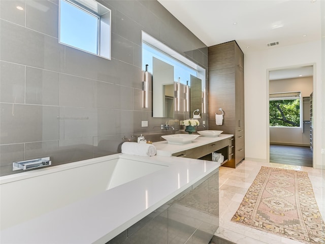 bathroom featuring tile walls and vanity