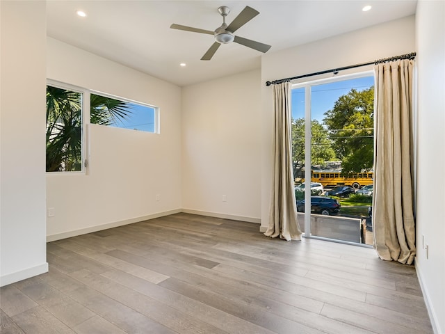 spare room featuring light wood-type flooring and ceiling fan