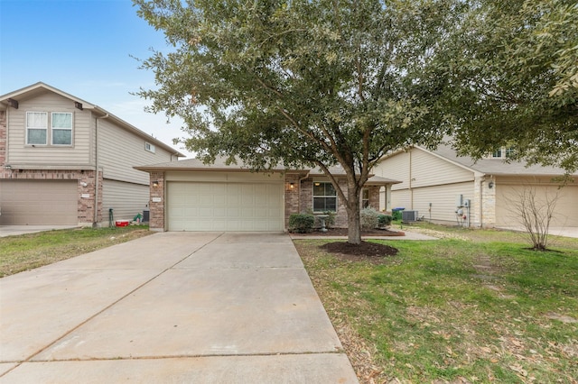 view of front of property featuring a garage, central AC unit, and a front lawn