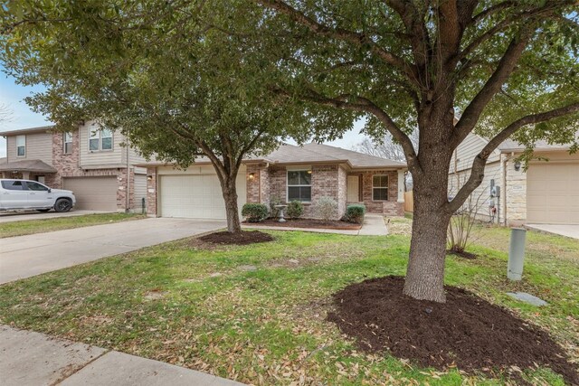 12206 Athens St, Manor, TX 78653 - view of front of property with driveway, a front yard, brick siding, and a garage