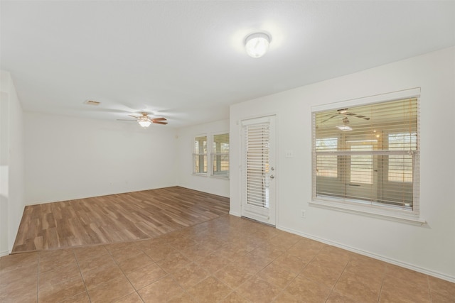 tiled empty room with ceiling fan