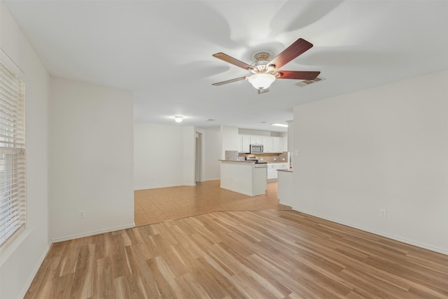 unfurnished living room with light hardwood / wood-style floors and ceiling fan