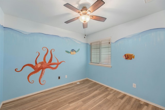 spare room with hardwood / wood-style flooring and ceiling fan