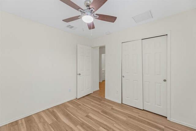 unfurnished bedroom with light hardwood / wood-style flooring, a closet, and ceiling fan