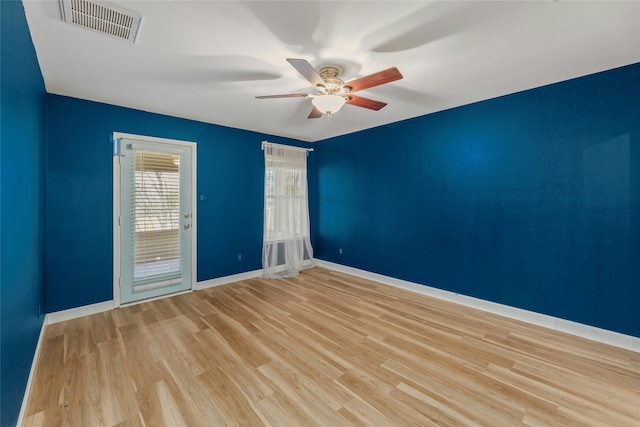 spare room featuring light wood-type flooring and ceiling fan