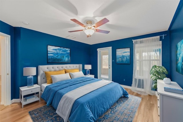 12206 Athens St, Manor, TX 78653 - bedroom with light wood-type flooring, a ceiling fan, and baseboards