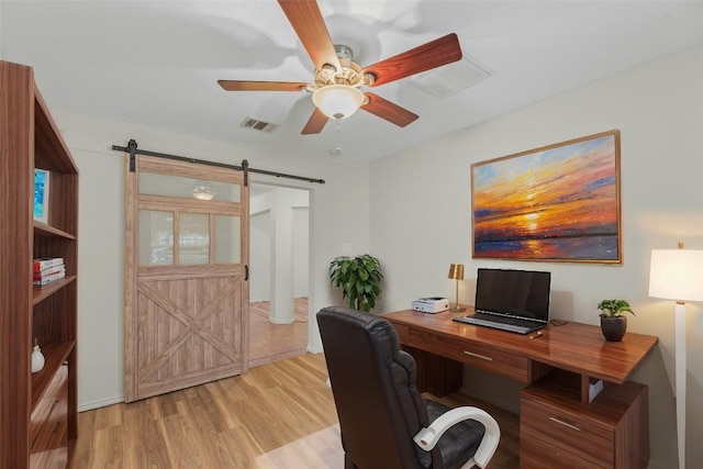 12206 Athens St, Manor, TX 78653 - office area with a barn door, light wood-style flooring, a ceiling fan, and baseboards