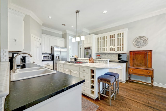 kitchen with a center island, decorative backsplash, sink, decorative light fixtures, and stainless steel appliances