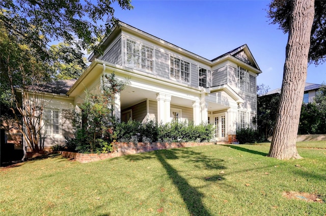 view of front of home featuring french doors and a front lawn