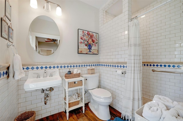 bathroom featuring sink, tile walls, a shower with curtain, and wood-type flooring