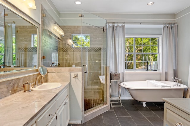 bathroom with tile patterned floors, vanity, and shower with separate bathtub