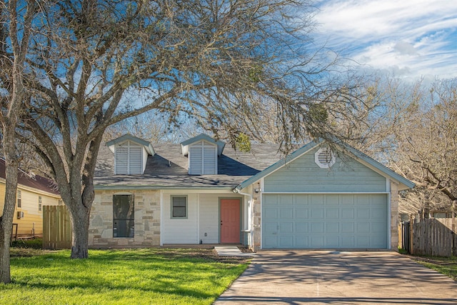 view of front of home with a garage and a front lawn