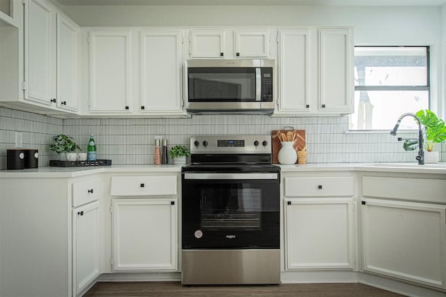 106 N Mockingbird Cir, Cedar Creek, TX 78612 - kitchen featuring appliances with stainless steel finishes and white cabinets