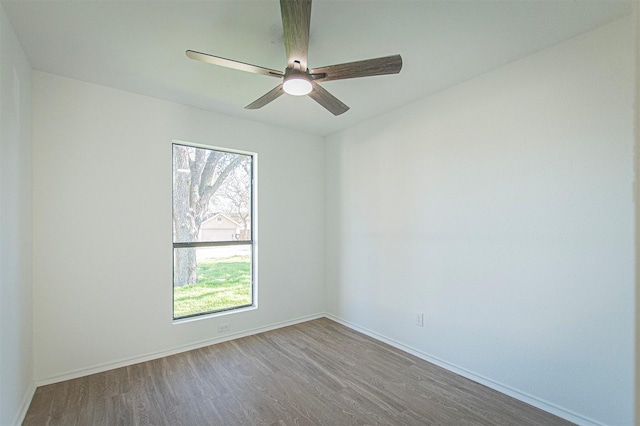 empty room featuring ceiling fan, a healthy amount of sunlight, and wood-type flooring