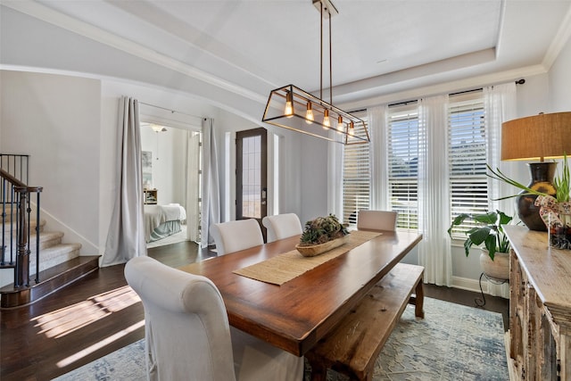 dining space with ornamental molding, a notable chandelier, and dark hardwood / wood-style flooring