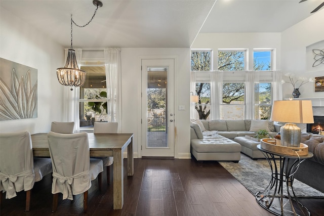 dining space with dark hardwood / wood-style flooring and an inviting chandelier