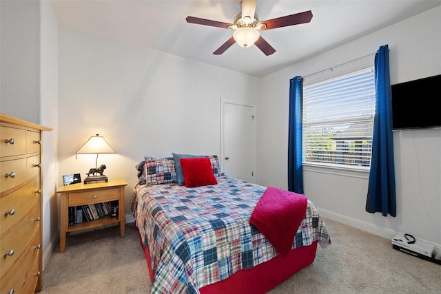 bedroom featuring light colored carpet and ceiling fan