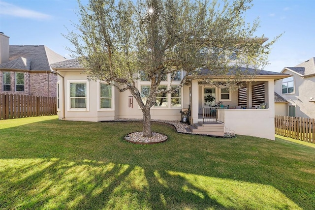 rear view of house with a lawn