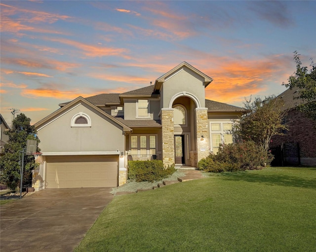 view of front of property featuring a garage and a lawn