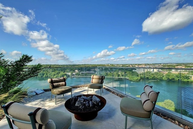 view of patio / terrace featuring a water view and an outdoor fire pit