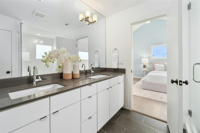 bathroom featuring vanity, a chandelier, and tile patterned flooring