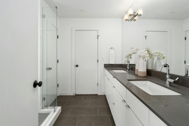 bathroom with vanity, a shower with shower door, and tile patterned floors