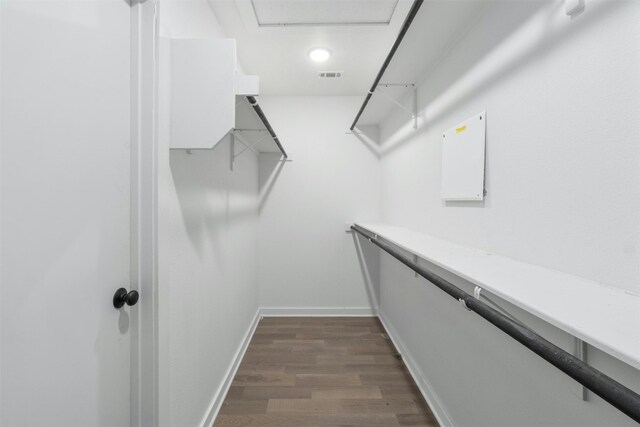 walk in closet featuring dark wood-type flooring