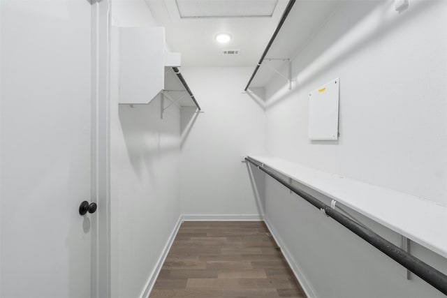 spacious closet featuring dark wood-type flooring