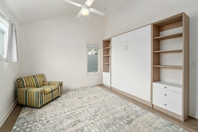 unfurnished room featuring ceiling fan, vaulted ceiling, and wood-type flooring