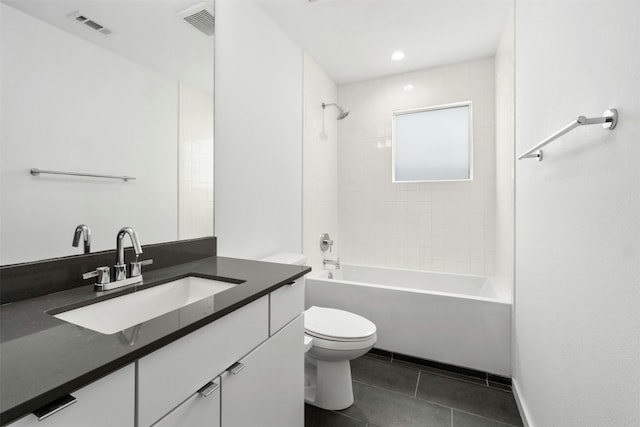 full bathroom with vanity, tile patterned flooring, toilet, and tiled shower / bath