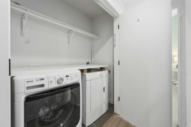 laundry area featuring dark hardwood / wood-style floors and washing machine and clothes dryer